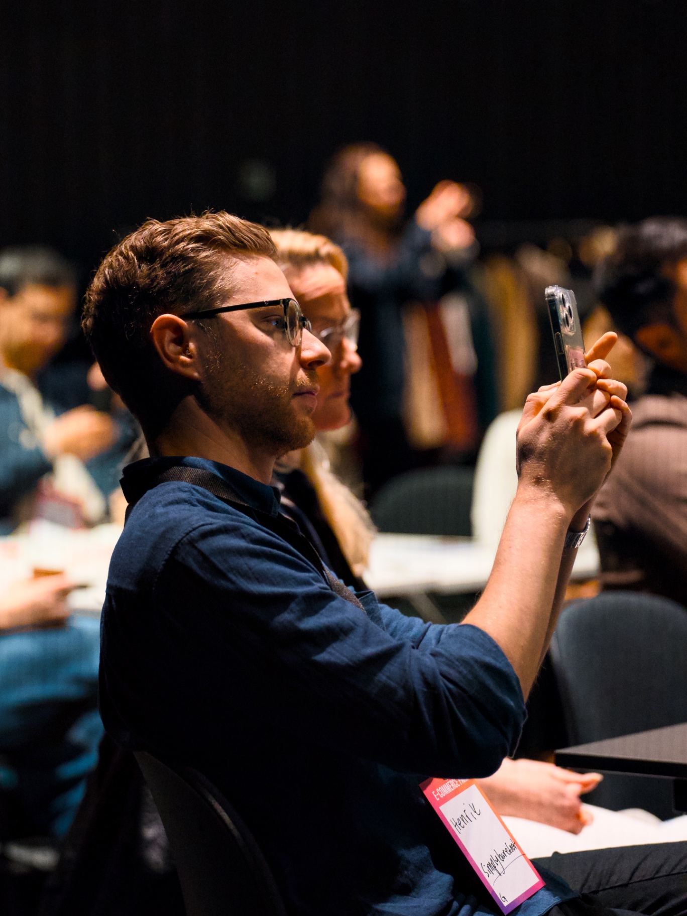 Attendee filming a talk at the E-COMMERCE MEETUP