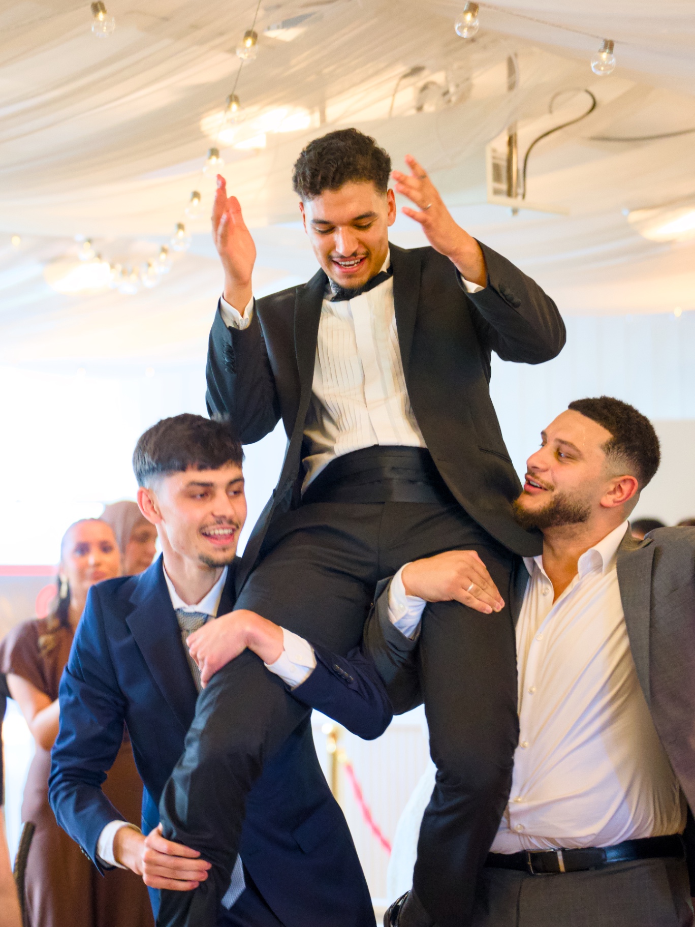 Groom lifted on the dance floor